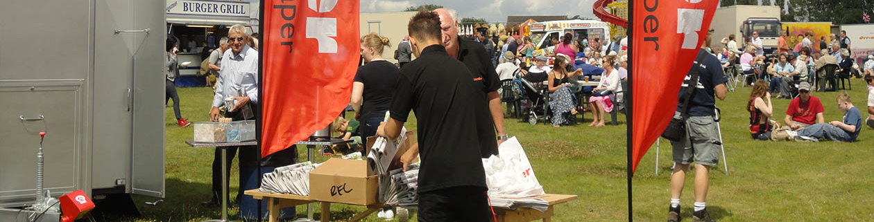 Picture of romford recorder handing out newspapers at the show