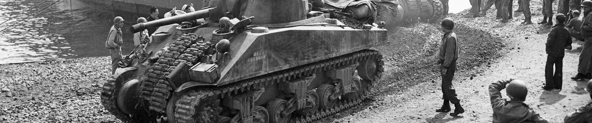 Picture of a US WW2 Tank with GI's looking on